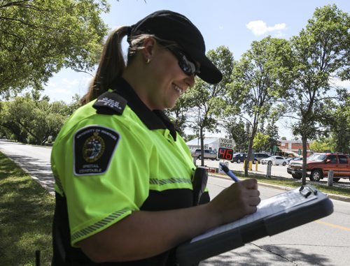 A mobile radar station on the University of Manitoba campus displays a driver's speed as he or she approaches, which is then recorded on a chart by a U of M special constable Trish Porter or one of her colleagues. Since the program's inception in July, the university has recorded 51% of drivers going 11 kilometres per hour or higher than the 30 km/h posted limit on internal roads. Tuesday, August 13, 2013. (NICK MARTIN) (JESSICA BURTNICK/WINNIPEG FREE PRESS)