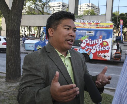 Councillor Mike Pagtakhan was downtown today to help announce the launch of the Downtown BIZ's third annual ManyFest on Broadway, which began with a food truck war between businesses Pimp My Rice, Habanero Sombrero and On A Roll. Wednesday, August 14, 2013. (ELIZABETH FRASER) (JESSICA BURTNICK/WINNIPEG FREE PRESS)