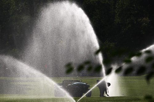 A maintenance worker adjusts sprinklers on the 18th hole of the Kildonan Golf Course Thursday morning-The fairways will need lots of water this week as highs are predicted to hit 34 C on Saturday in Winnipeg-Standup Photo- August 15, 2013   (JOE BRYKSA / WINNIPEG FREE PRESS)