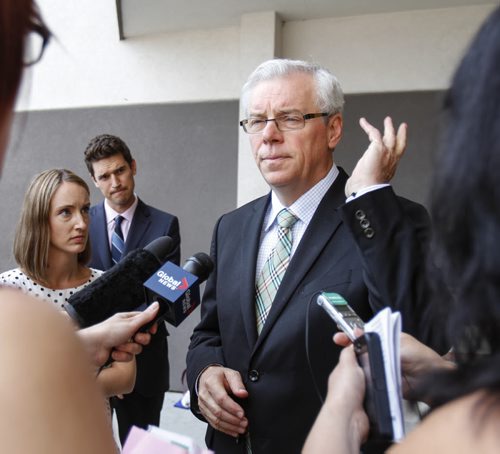 Premier Greg Selinger shoes away a fly as he speaks to the media outside the Viscount Gort Hotel on Portage Ave. following the announcement of a new park plaza, the Arden Seven Interpretive Plaza, to be located in Jules Mager Park. Friday, August 16, 2013.  (OLIVER SACHGAU) (JESSICA BURTNICK/WINNIPEG FREE PRESS)