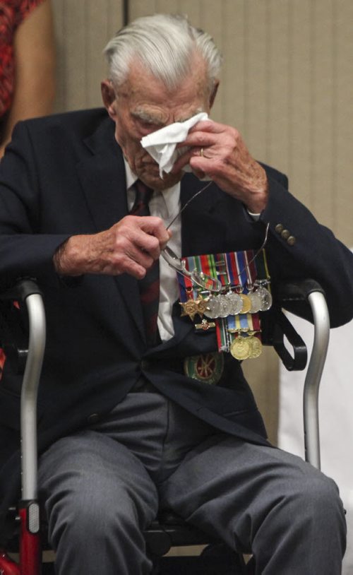 George Peterson, the sole surviving member of the Arden Seven, dabs his eyes with a handkerchief during the dedication of a new park plaza in honour of himself and his six comrades who grew up on Arden Ave. in Winnipeg. They volunteered, fought and were captured during the Battle of Hong Kong during the Second World War in 1941. The Arden Seven Interpretive Plaza, to be located in Jules Mager Park in St. Vital, commemorates comrades Fred Abrahams, twins Morris and George Peterson, and brothers Alfred, Edward and Harry Shayler, all of whom survived the battle of Hong Kong. Friday, August 16, 2013.  (OLIVER SACHGAU) (JESSICA BURTNICK/WINNIPEG FREE PRESS)