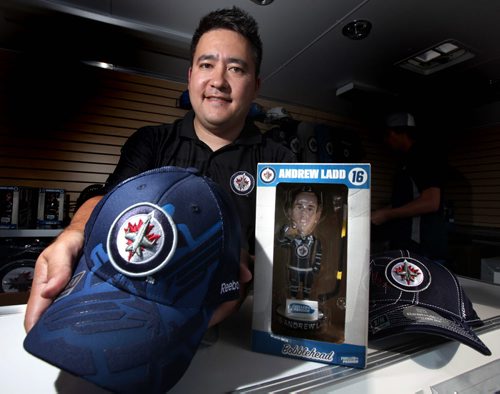 Dan Suga shows off some of the Jet's merchandise at a mobile "Jets Gear Store" in Stonewall at the Quarry Days festival site. See Kirbyson's story. August 16, 2013 - (Phil Hossack / Winnipeg Free Press)