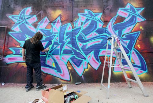 Kelly Graval, aka Risk, an artist from Los Angeles works on a large piece at the Graffiti Gallery on Higgins Avenue, Saturday, August 17, 2013. Graval was a guest judge during the graffiti battle featuring 29 participants. (TREVOR HAGAN/WINNIPEG FREE PRESS)