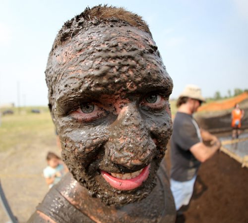 Alex Teitsma was all smiles after completing the Dirty Donkey Run, a 5km run through a muddy obstacle course, at Springhill, Saturday, August 17, 2013. (TREVOR HAGAN/WINNIPEG FREE PRESS)