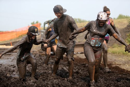Participants near the finish line of the Dirty Donkey Run, a 5km run through a muddy obstacle course, at Springhill, Saturday, August 17, 2013. (TREVOR HAGAN/WINNIPEG FREE PRESS)