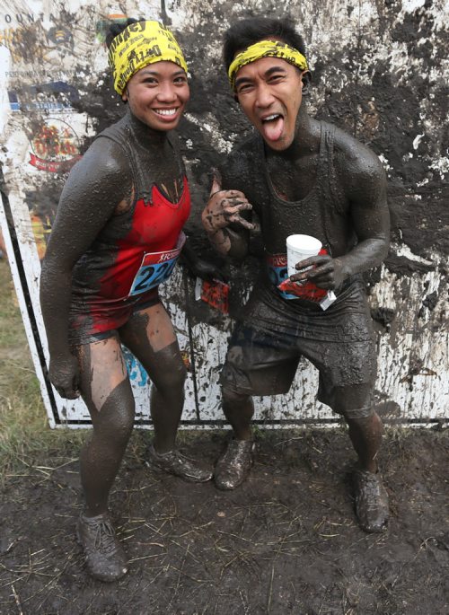 Reyna Domingo and Christian Tabios after completing the Dirty Donkey Run, a 5km run through a muddy obstacle course, at Springhill, Saturday, August 17, 2013. (TREVOR HAGAN/WINNIPEG FREE PRESS)