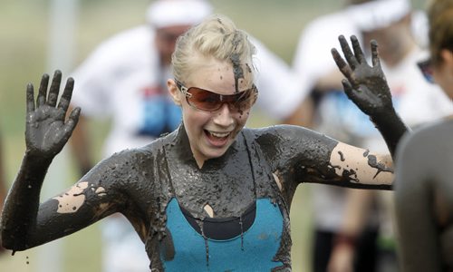 A participant nears the finish line of the Dirty Donkey Run, a 5km run through a muddy obstacle course, at Springhill, Saturday, August 17, 2013. (TREVOR HAGAN/WINNIPEG FREE PRESS)