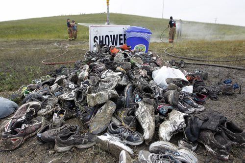 Discarded shoes after the finish line of the Dirty Donkey Run, a 5km run through a muddy obstacle course, at Springhill, Saturday, August 17, 2013. (TREVOR HAGAN/WINNIPEG FREE PRESS)