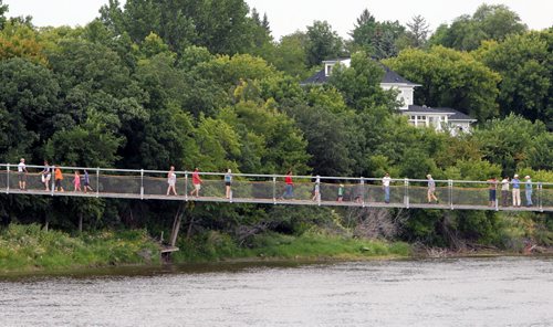 Brandon Sun 17082013 Visitors to Souris, Manitoba check out the new swinging bridge on Saturday after the bridge was reopened after it was calibrated earlier in the week. An official grand opening for the bridge is planned for a later date.  (Tim Smith/Brandon Sun)