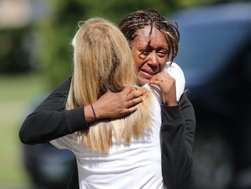 A woman in tears at the scene of a fire at a house on Tanoak Park Drive, Sunday, August 18, 2013. (TREVOR HAGAN/WINNIPEG FREE PRESS)