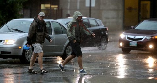 Pedesrtians crossing Donald at Broadway during a rain storm, Sunday, August 18, 2013. (TREVOR HAGAN/WINNIPEG FREE PRESS)