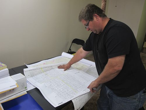 In his Reston, Man. office, Williamson Trucking owner Wes Omichinski looks over a map of the RM of Pipestone, home to the oilwells of the Sinclair Field. Demand for transport services has intensified in the once-quiet municipality. August 18, 2013 BARTLEY KIVES / WINNIPEG FREE PRESS