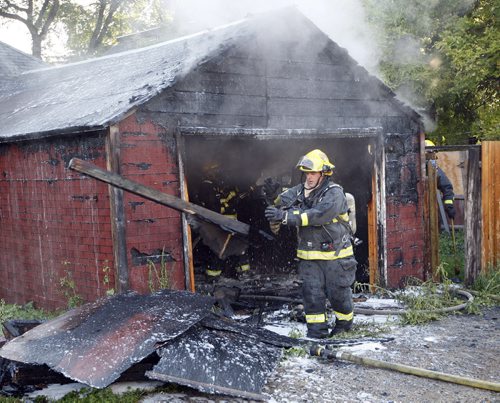 Wpg Fire crews quickly put out a garage fire at the rear of a house in the 500 block of Boyd Ave just west of Powers Ave  , the fire started  just before 8am and sent a column of black smoke over the area . No injuries . KEN GIGLIOTTI / Aug 19 2013 / WINNIPEG FREE PRESS