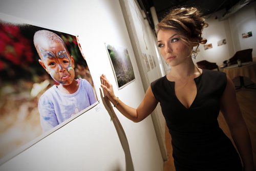 August 19, 2013 - 130819  -  Tracy Tomchuk, a fine arts graduate, is photographed at her photography exhibit at  Frame Arts Warehouse Monday, August 19, 2013. Tomchuk went to work in a Tanzanian orphanage and take photographs and now wants to get her nursing degree and return to help. John Woods / Winnipeg Free Press