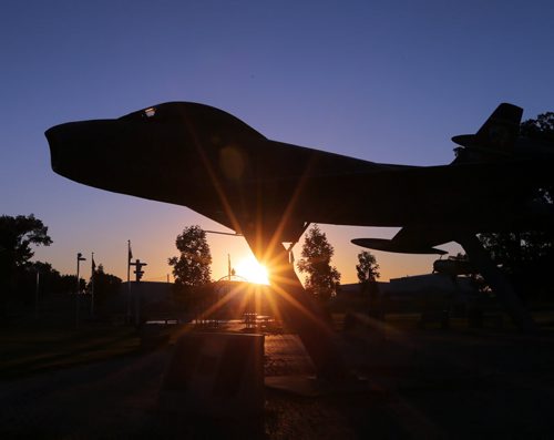 Stdup- Sunrise over the 17 Wing Garden of Memories featuring  F-86 Sabre fighter ,one of many   Canadian  Forces fighters , patrol and training preserved outside the 17 Wing gate  on Airforce Way . Temps will hit+33 again today . KEN GIGLIOTTI / Aug 20 2013 / WINNIPEG FREE PRESS
