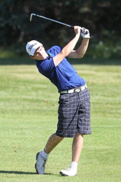 Brandon Sun 18082013 Joel Baron of Carberry hits from the fairway during junior men's medal play at the Tamarack Golf Tournament at Clear Lake Golf Course on Monday. (Tim Smith/Brandon Sun)