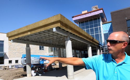 Superintendant Vern Reimer shows the outside of the Northlands Parkway Collegiate that will open this September-See Nick Martin story- August 20, 2013   (JOE BRYKSA / WINNIPEG FREE PRESS)