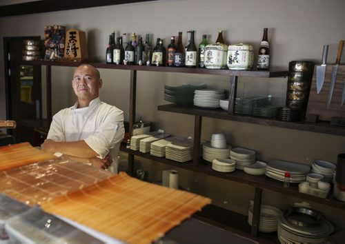 Edward Lam, behind the sushi bar, is the head chef and co-owner of Yujiro Japanese Restaurant located at 1822 Grant Ave. in Winnipeg. Tuesday, August 20, 2013. (JESSICA BURTNICK/WINNIPEG FREE PRESS)