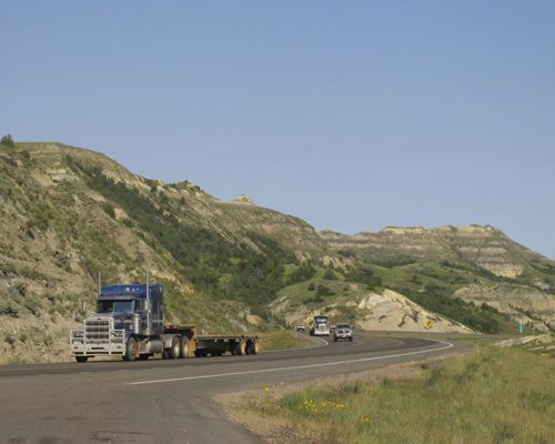 Oilpatch traffic crosses the Little Missouri River bandlands on U.S. Route 8, a once-quiet thoroughfare that runs alongside Theodore Roosevelt National Park. August 20 2013. BARTLEY KIVES/WINNIPEG FREE PRESS