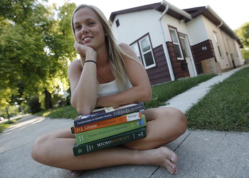 August 20, 2013 - 130820  -  Kristen Coleman, a nursing student who has thousands of dollars of student  debt, is photographed in front of her home Tuesday, August 20, 2013.  Coleman has returned to school to get a nursing degree after finding out she could not get a job with her Bachelor of Arts degree.  John Woods / Winnipeg Free Press