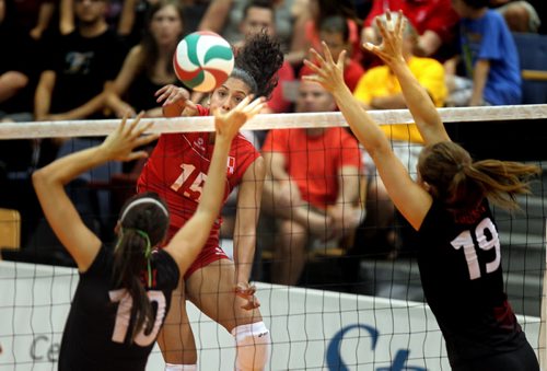 Peru's #15 Karla Ortiz takes aim through the Canadian defence in exhibition volleyball at U of W Tuesday evening. August 20, 2013 - (Phil Hossack / Winnipeg Free Press)