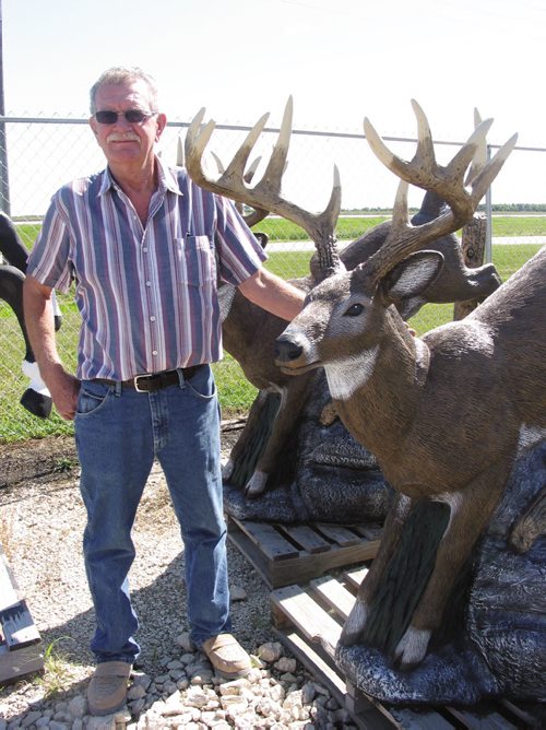 Canstar Community News Aug. 13, 2013 - Owner of Oranamental Stonecraft in Oak Bluff, Rod Schroeder stands next to his largest concrete lawn ornament. (ANDREA GEARY/CANSTAR COMMUNITY NEWS)