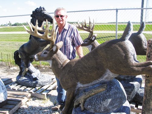 Canstar Community News Aug, 13, 2013 - Rod Schroeder, owner of Ornamental Stonecraft in Oak Bluff, shows off his company's largest piece of lawn statuary. (ANDREA GEARY/CANSTAR COMMUNITY NEWS)