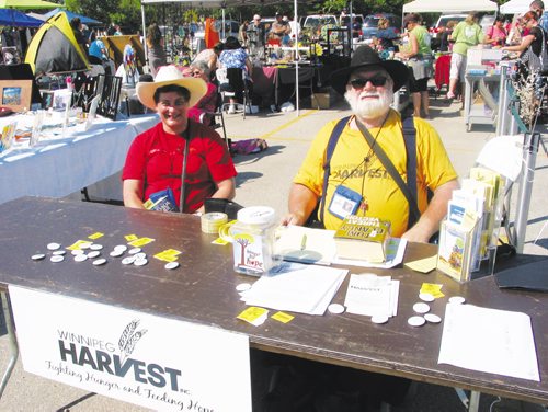 Canstar Community News Aug. 11, 2013 - Volunteers Bev and Bernie Krahn collect donations for Winnipeg Harvest at a farmers market held on Aug. 11 at Shelmerdine Garden Centre, Headingley. (ANDREA GEARY/CANSTAR COMMUNITY NEWS)