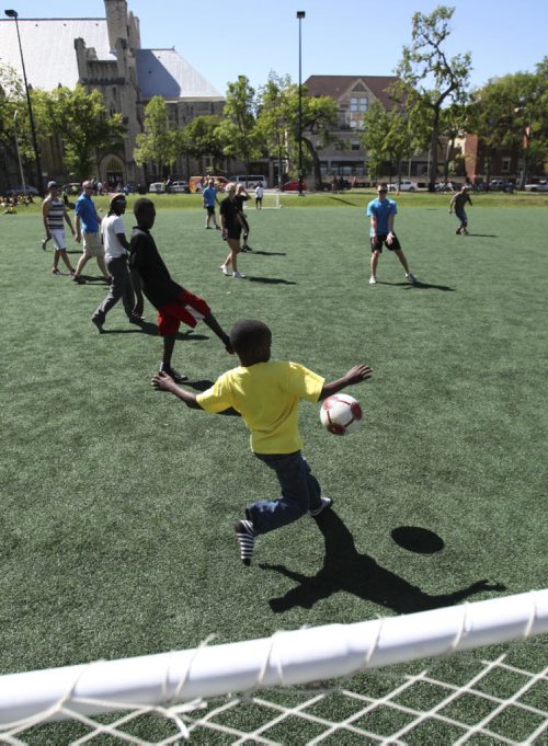 The Winnipeg Police Cadets play a round of soccer with neighbourhood children in Winnipeg's Central Park during the third annual Kickin' It With Cadets event on Wednesday, August 21, 2013. (JESSICA BURTNICK/WINNIPEG FREE PRESS)