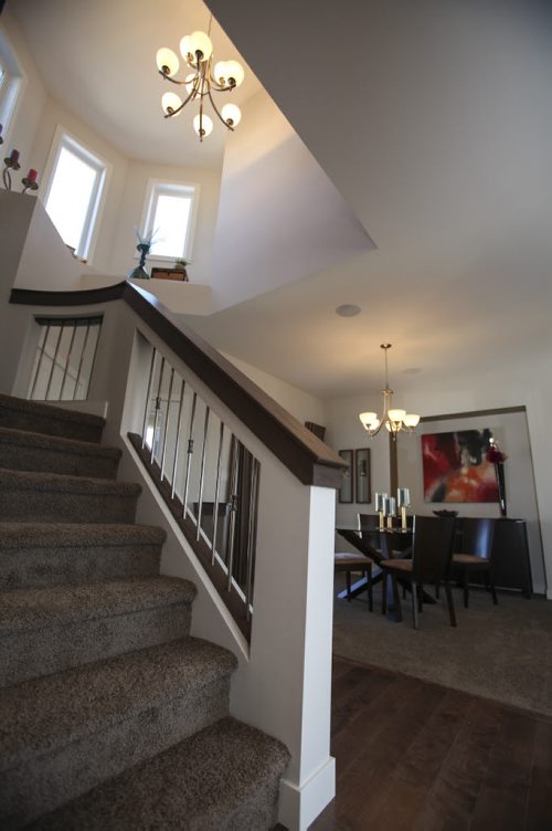(Stairwell and dining room) This A&S Homes show home located at 10 Tychonick Bay in Kildonan Green features 3 bedrooms, two and a half bathrooms, and modern open living spaces on the main floor. Wednesday, August 21, 2013. (JESSICA BURTNICK/WINNIPEG FREE PRESS)