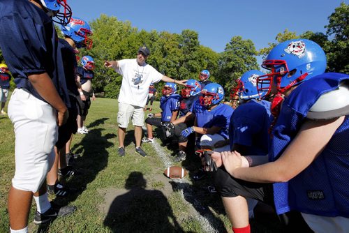Churchill Highschool Bulldogs football team practice in town before they head to New York for a school trip. The coach Tom Walls, in white, used to coach in New York. Kyle Jahns story. BORIS MINKEVICH / WINNIPEG FREE PRESS. August 21, 2013.