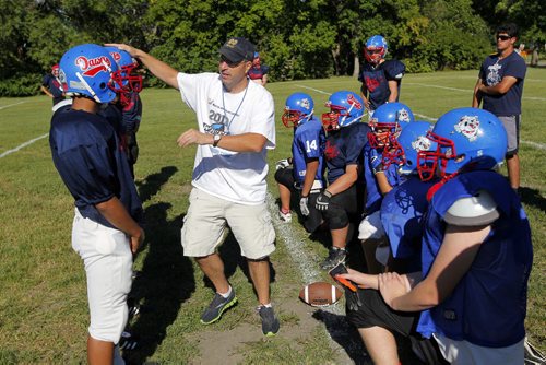 Churchill Highschool Bulldogs football team practice in town before they head to New York for a school trip. The coach Tom Walls, in white,  used to coach in New York. Kyle Jahns story. BORIS MINKEVICH / WINNIPEG FREE PRESS. August 21, 2013.
