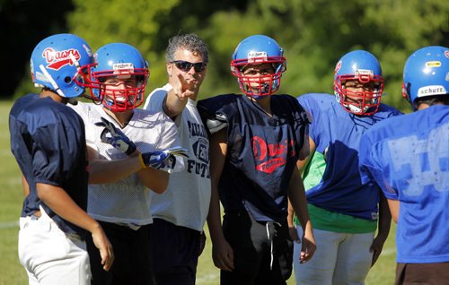 Churchill Highschool Bulldogs football team practice in town before they head to New York for a school trip.  Kyle Jahns story. BORIS MINKEVICH / WINNIPEG FREE PRESS. August 21, 2013.