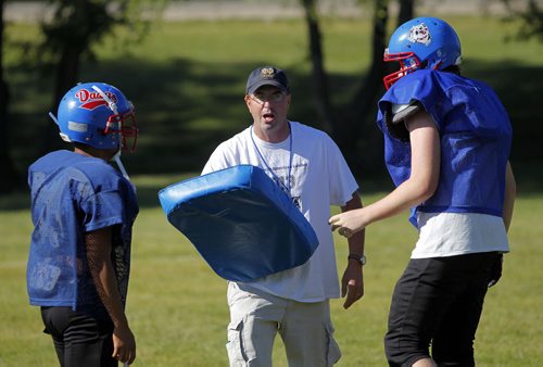 Churchill Highschool Bulldogs football team practice in town before they head to New York for a school trip. The coach Tom Walls, middle, used to coach in New York. Kyle Jahns story. BORIS MINKEVICH / WINNIPEG FREE PRESS. August 21, 2013.