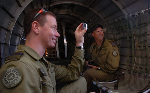 Brandon Sun Helicopter pilots Tim Rudolph and Mike Houle, of the 3CFFTS squadron in Portage la Prairie, watch through the waist-gunner windows during take-off on Wednesday morning in the Sentimental Journey B-17. (Bruce Bumstead/Brandon Sun)
