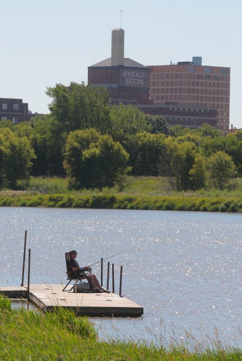 Brandon Sun Norm Desaulniers relaxes with the fishing pole on Wednesday afternoon at the Dinsdale Park docks in the hopes of landing a catfish or pickerel. (Bruce Bumstead/Brandon Sun)