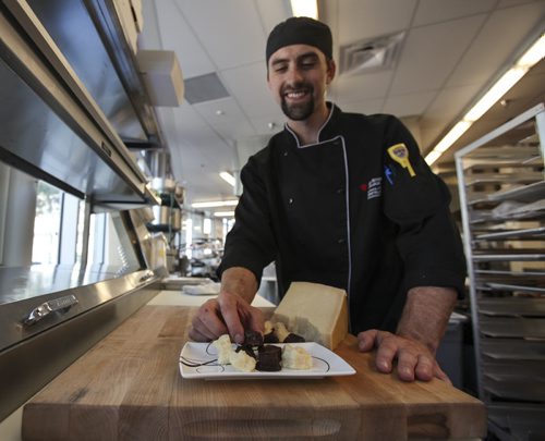 Kyle Otter, a chef apprentice at the Red River College School of Hospitality and Culinary Arts, puts together chocolate dipped parmigiano-reggiano (chocolate covered parmesan cheese). Thursday, August 22, 2013. (JESSICA BURTNICK/WINNIPEG FREE PRESS)