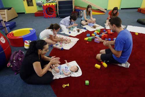 mother sit in semi circle with their newborns engaging the children with sound and movement - Childhood Obesity Äì The My Gym location specializes in fitness for infant and young children  - storey by Randy Turner fr 49.8  KEN GIGLIOTTI / Aug 22 2013 / WINNIPEG FREE PRESS