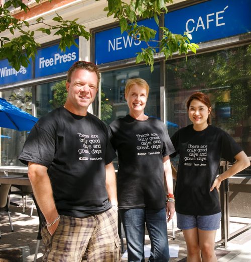 Free Press columnist Lindor Reynolds (centre) is joined by reporter Geoff Kirbyson and Free Press News Caf¾© manager Eunice Kim. Reynolds, who has been diagnosed with brain cancer, is selling Team Lindor t-shirts to fundraise for CancerCare Manitoba.  130822 - Thursday, August 22, 2013 - (Melissa Tait / Winnipeg Free Press)