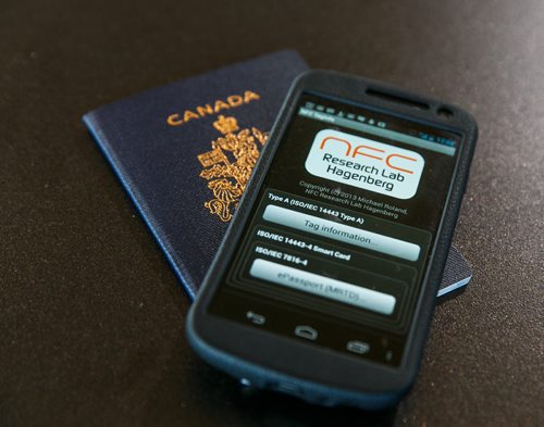 The new Canadian passports include a security chip in the cover that can be read by any near field communication (NFC) application on a smartphone.  See story by Oliver Sachgau 130821 - Wednesday, August 21, 2013 - (Melissa Tait / Winnipeg Free Press)