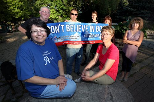Donna Harris, (front left) and Dorothy Stephens pose in front of Bob Russell, Grant Rogerson, Paul Morrow, Diana Goods and her daughter Katie (left to right rear.) Members of HAAM (Humanists, Athiests and Agnostics Manitoba are off to the Corn and Apple Festival in the heart of the Bible Belt to support those who don't beleive in God. See story. August 22, 2013 - (Phil Hossack / Winnipeg Free Press)