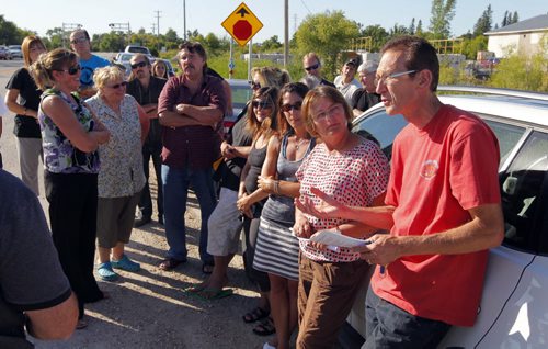 Homeowners who oppose a proposed sewage lagoon in East Selkirk say the province made a mistake by issuing a licence to build it. One of the groups key people is in red on right, Dennis Petaski. BORIS MINKEVICH / WINNIPEG FREE PRESS. August 22, 2013.