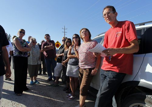 Homeowners who oppose a proposed sewage lagoon in East Selkirk say the province made a mistake by issuing a licence to build it. One of the groups key people is in red on right, Dennis Petaski. BORIS MINKEVICH / WINNIPEG FREE PRESS. August 22, 2013.