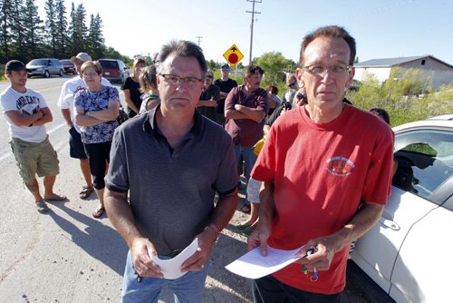 Homeowners who oppose a proposed sewage lagoon in East Selkirk say the province made a mistake by issuing a licence to build it. Two of the groups key people are Al Prue, left and on right, Dennis Petaski. BORIS MINKEVICH / WINNIPEG FREE PRESS. August 22, 2013.