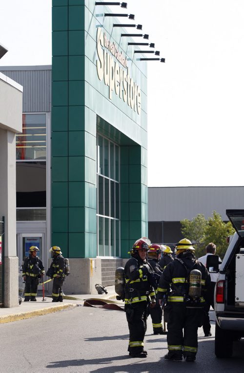 Fire Fighters put out a small fire broke out send staff and customers fleeing the smokey St. James St Superstore , one customer Maria Fostes said she saw flame & smoke  coming from the electronics area , where TV and electronic games were on display . KEN GIGLIOTTI / Aug 23 2013 / WINNIPEG FREE PRESS