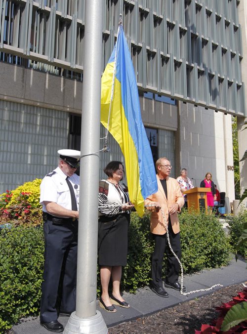 Mayor Sam Katz, right,  joins Ukrainian Canadian Congress' Marijka Diakiw to raise the Ukranian national flag at city hall. BORIS MINKEVICH / WINNIPEG FREE PRESS. August 23, 2013.