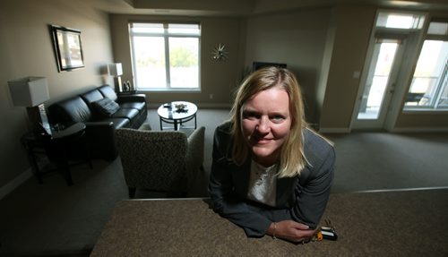 SANDY SAGER, (poses in one of the Condos) business development officer and co-owner of the local Premiere Executive Suites franchise, which runs the chains extended-stay operations in Manitoba and Saskatchewan. The local franchise is the latest commercial tenant  to lease space in one of the Waterfront Drive condo developments, which have had a tough time finding tenants for their main-floor commercial space. Its setting up its new regional office there, but it also leases units in local condo buildings like the ones  on Waterfront and in the East Exchange and rents them out as extended-stay suites. August 22, 2013 - (Phil Hossack / Winnipeg Free Press)