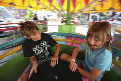 Friends Emma Duncan (right) and Braeden Dance take a spin on a teacup-type ride on the midway. Established in 1967, the Morden Corn and Apple Festival is the town's chief attraction, and is always held in the fourth week of August. Friday, August 23, 2013. (JESSICA BURTNICK/WINNIPEG FREE PRESS)