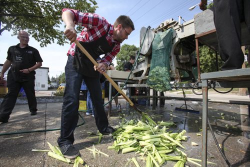 Someone has to clean up after the husking machine. Established in 1967, the Morden Corn and Apple Festival is the town's chief attraction, and is always held in the fourth week of August. Friday, August 23, 2013. (JESSICA BURTNICK/WINNIPEG FREE PRESS)