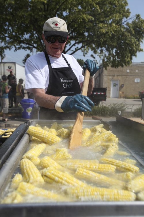 Jack Zacharias stirs up the corn cobs in a vat of boiling water. Established in 1967, the Morden Corn and Apple Festival is the town's chief attraction, and is always held in the fourth week of August. Friday, August 23, 2013. (JESSICA BURTNICK/WINNIPEG FREE PRESS)